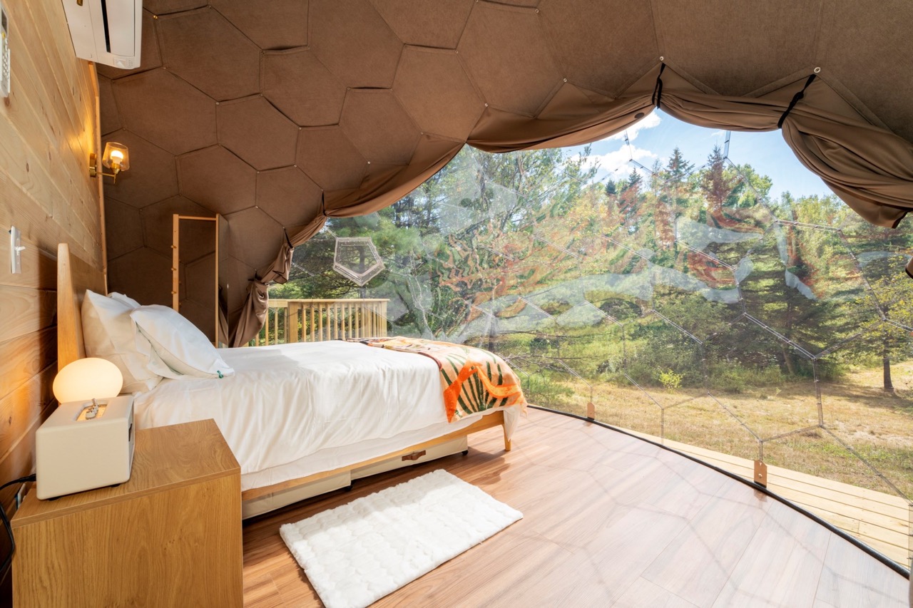 Blick aus einem Erkerfenster im Inneren eines Nova Nook Glamping Domes