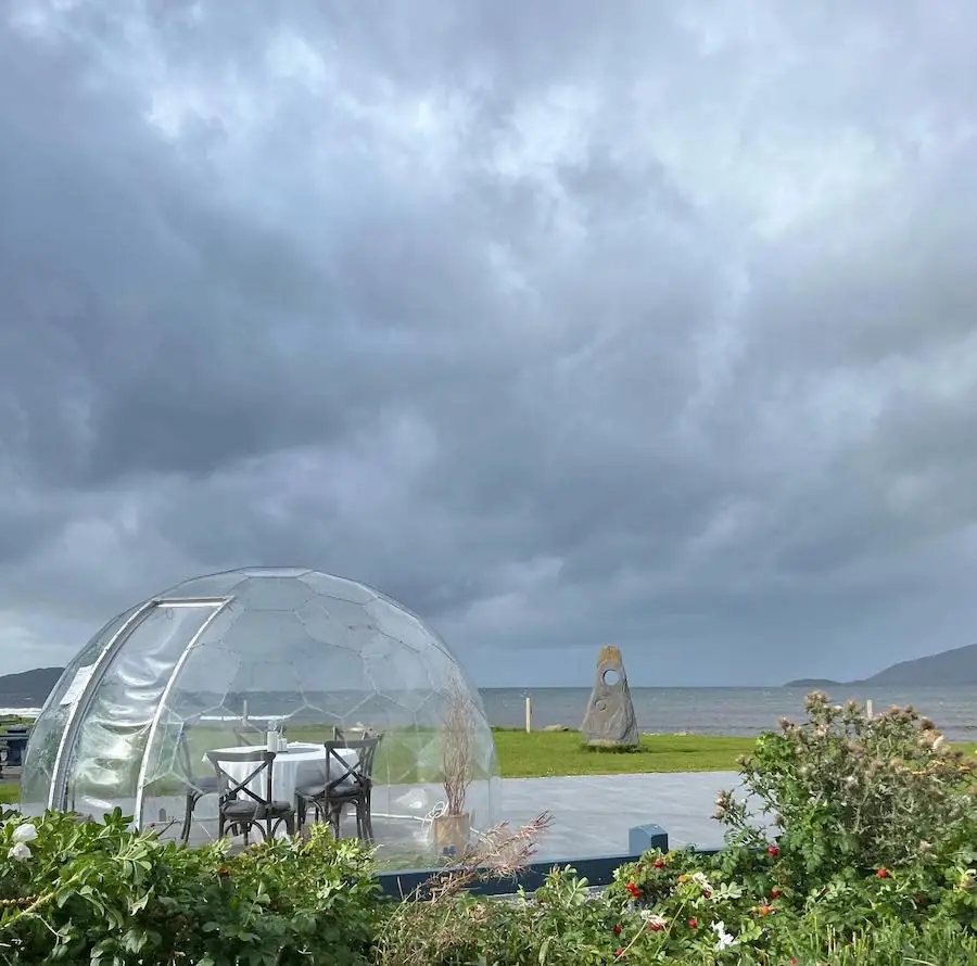 Hypedome on the coast with dark storm clouds gathering in the background