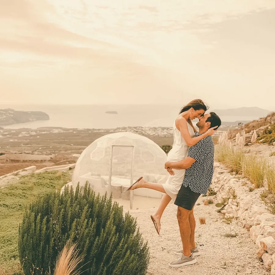 A couple enjoying their Hypedome with the sea behind them