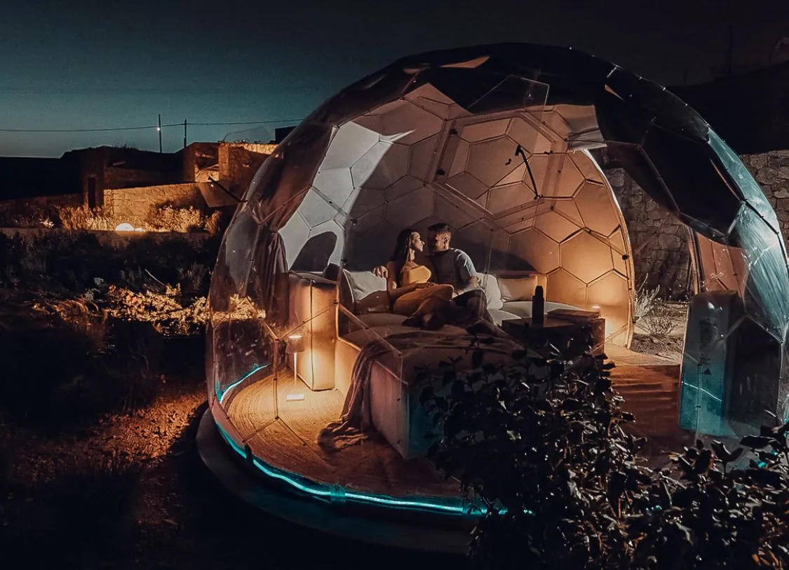 A couple in a glamping dome