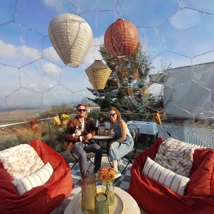 Holley and Kevin and their dog inside a Hypedome on a terrace