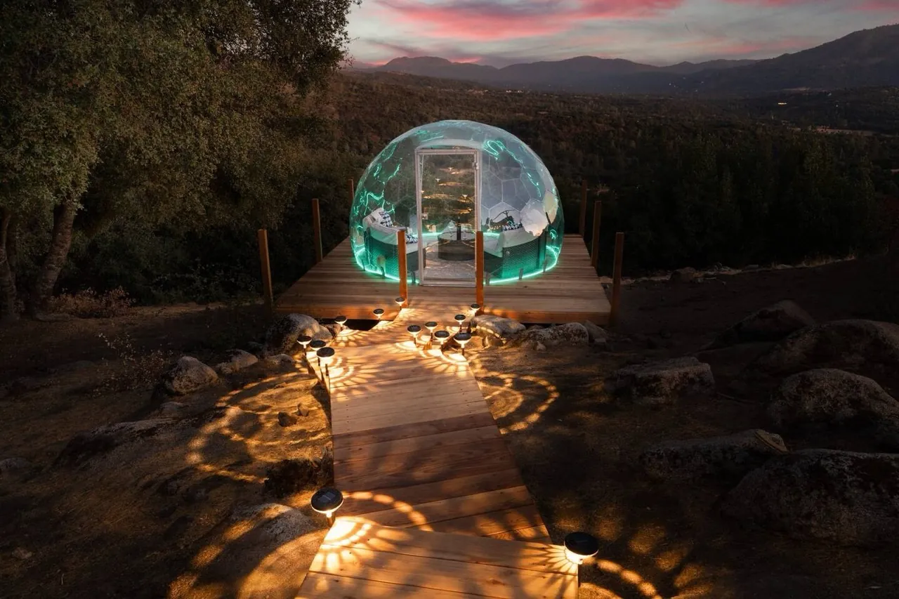 A sleek outdoor room in a backyard dome